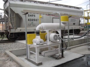 A blower package as part of a pneumatic conveying system unloading a railcar.