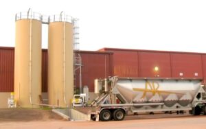 US Systems Truck Unloading Station Conveys Material Into a Silo