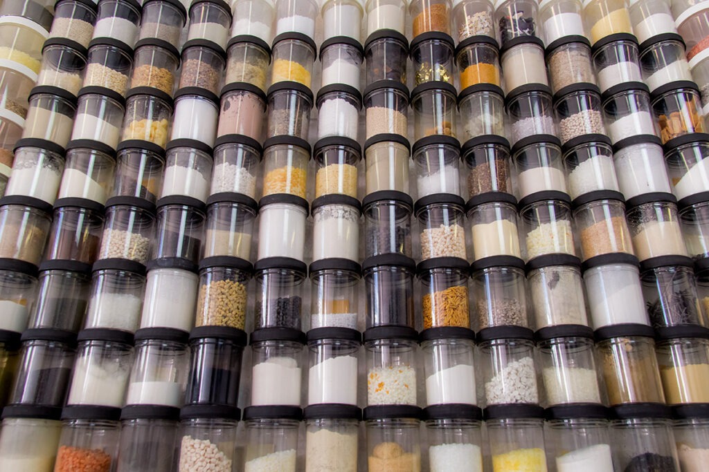 Jars of dry bulk material samples for pneumatic conveying at US Systems.